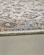 Beritham rug close-up showing dense distressed texture and multicolor speckled floral pattern