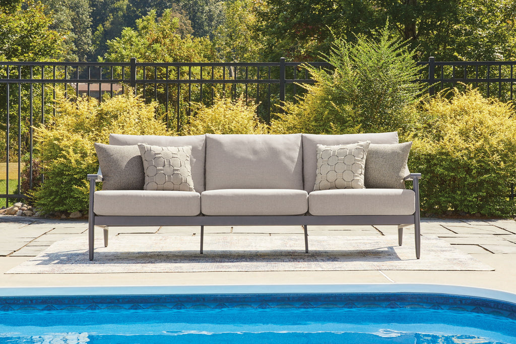 Gray outdoor sofa with cushions and three back pillows, dark metal frame