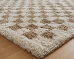 Beige rug with brown check motif, textured close-up