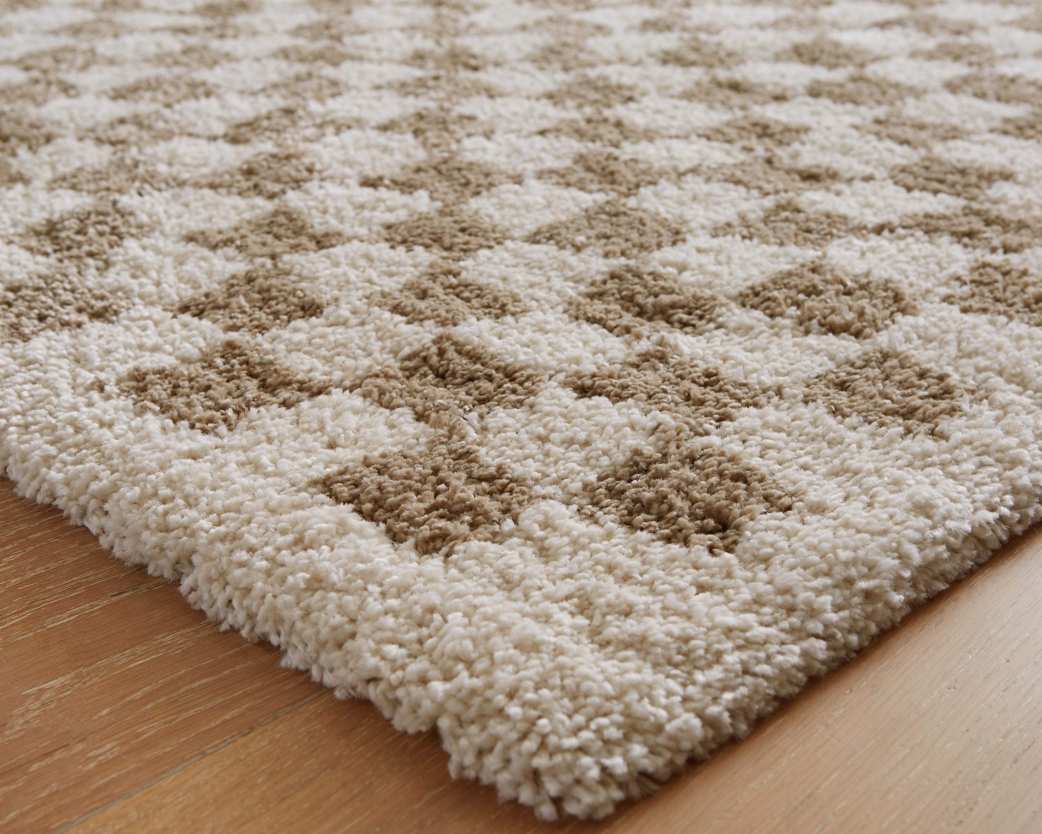 Beige rug with brown check motif, textured close-up