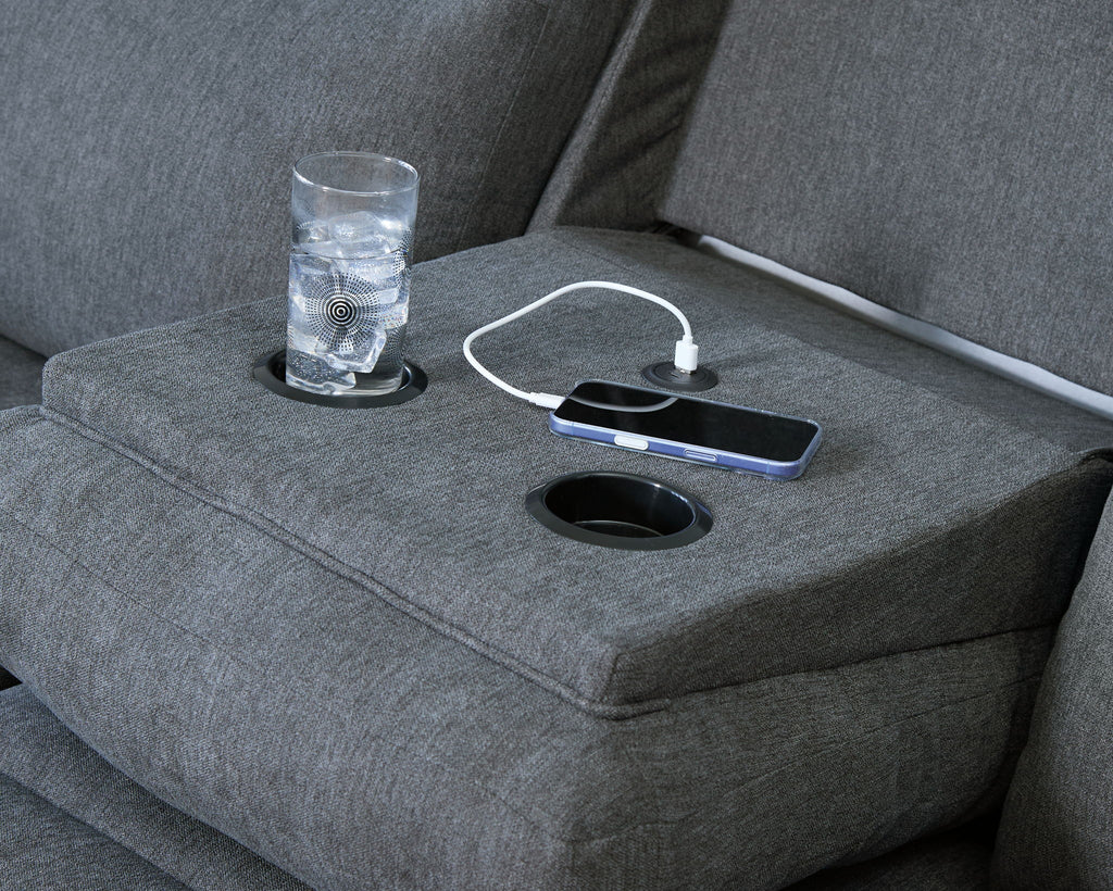 Dark gray recliner console with cup holder and smartphone resting on built-in tray