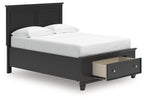 Black panel bed with one front drawer and a white upholstered mattress and pillows.