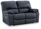 Power reclining loveseat, dark blue faux leather with padded arms and reclining seats