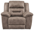 Taupe recliner chair with cushioned headrest, padded arms, and center seam panel