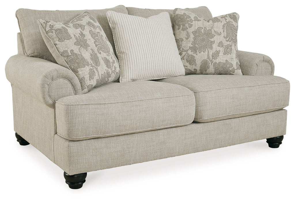 Light gray loveseat with three pillows, cushioned arms, and dark tapered legs.