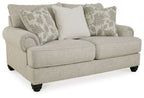 Light gray loveseat with three pillows, cushioned arms, and dark tapered legs.
