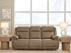 Power reclining sofa with adjustable headrests in taupe leather-look upholstery, wide arms