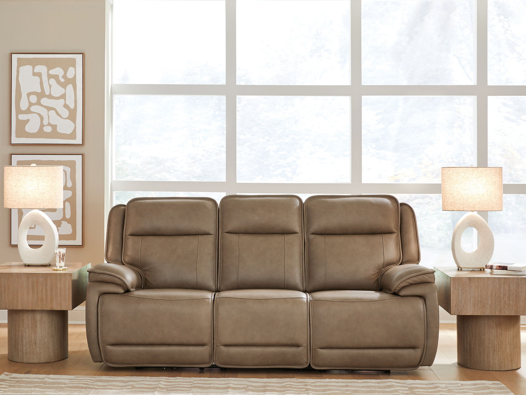 Power reclining sofa with adjustable headrests in taupe leather-look upholstery, wide arms