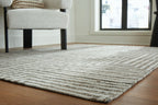 Gray textured chevron rug surface with flat weave and short pile
