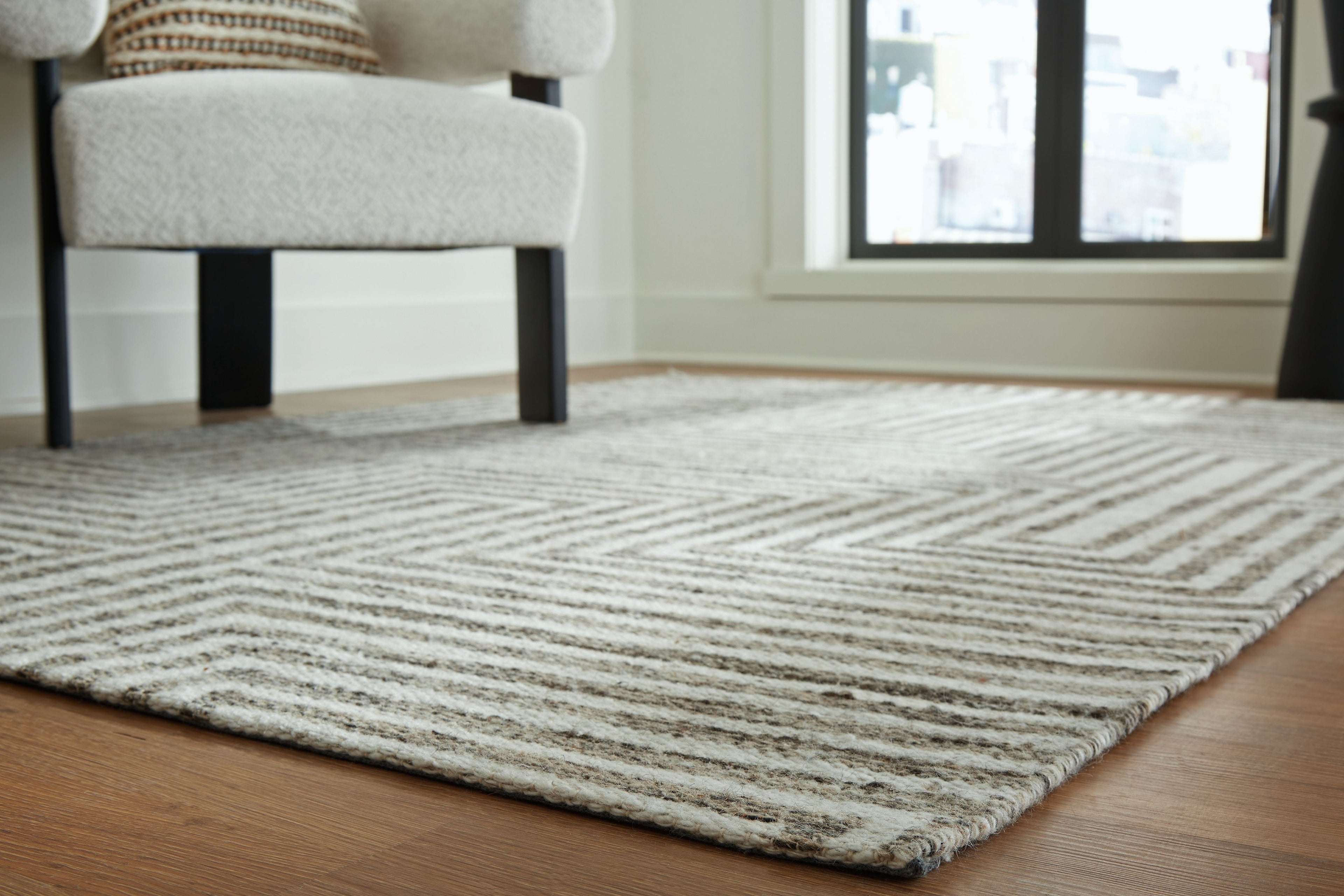 Gray textured chevron rug surface with flat weave and short pile