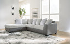 Light gray corner sectional sofa with chaise and striped accent pillows.