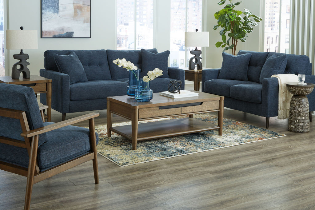 Blue upholstered sofa set with three seating pieces and decorative throw pillows