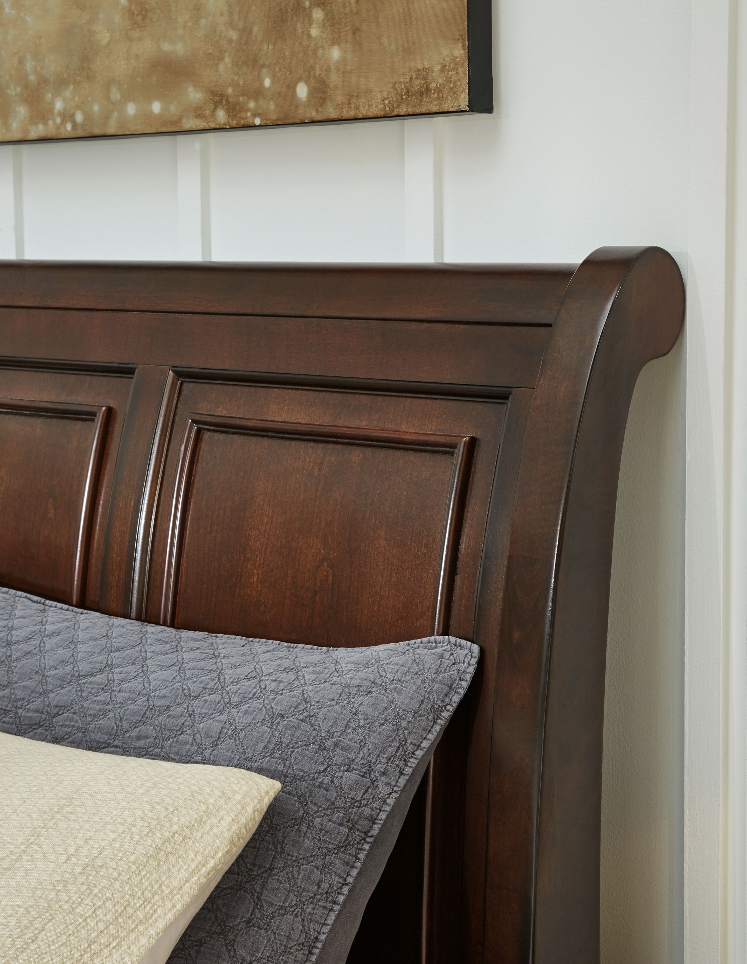 Dark brown sleigh bed headboard with arched top and recessed panel molding