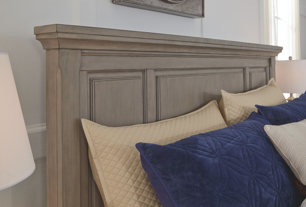 Lettner sleigh bed side panel with blue and cream pillows on gray frame