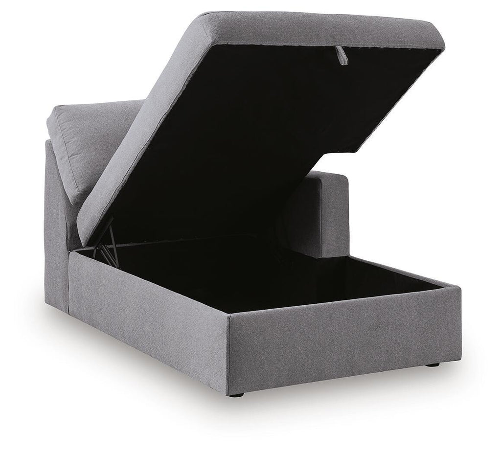 Gray corner chaise storage box with open lid, showing dark interior