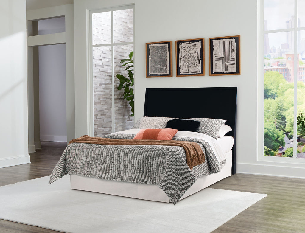 Panel headboard in black upholstered backing for bed with pillows