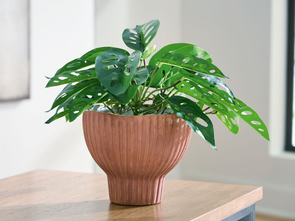 Sienna ribbed vase on tabletop with leafy plant