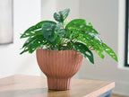 Sienna ribbed vase on tabletop with leafy plant
