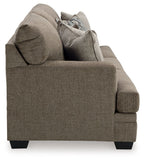 Corner view of a sofa sleeper with taupe upholstery, rounded arms, and two back cushions