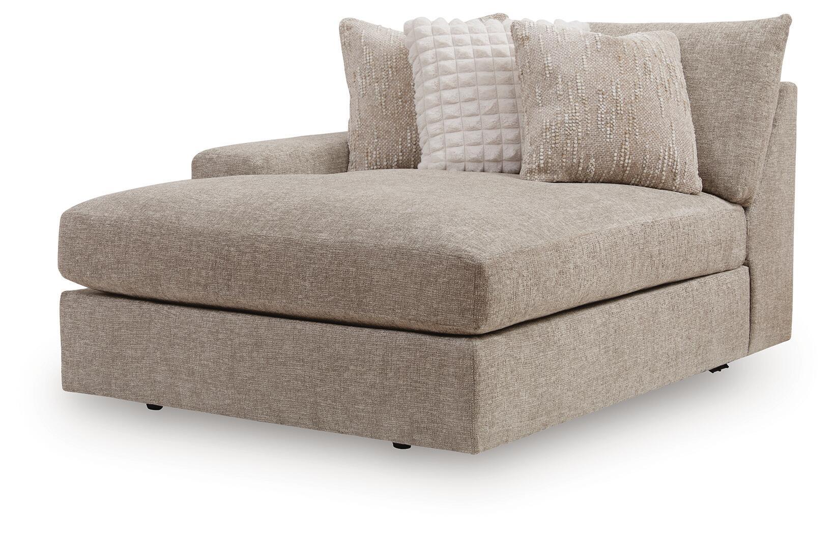 Gray fabric corner chaise with wide seat, low arms, and three decorative pillows
