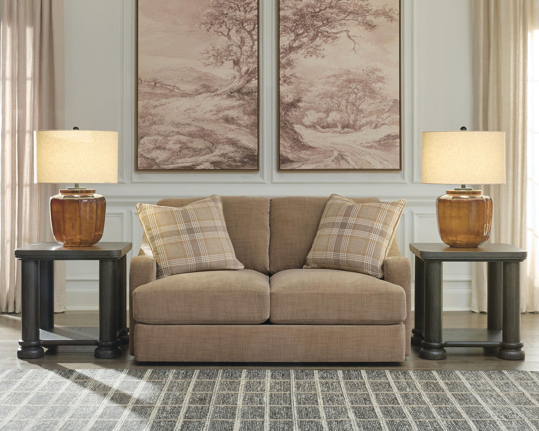 Beige loveseat with plaid accent pillows and rounded seat cushions, front view