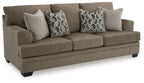 Stonemeade sofa in dark taupe fabric with two geometric patterned throw pillows