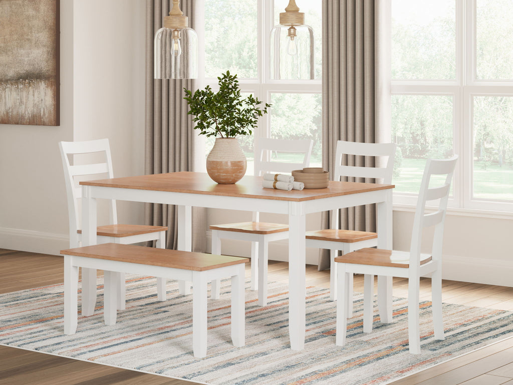 Dining table set with light wood tabletop, white chairs, and bench for seating