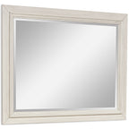Antique white bedroom mirror with beveled frame and reflective glass panel