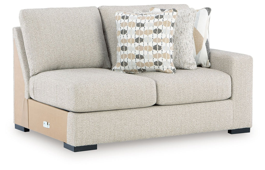 Pebble light-gray loveseat with two front cushions and patterned throw pillows