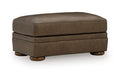 Brown upholstered ottoman with padded top and short legs