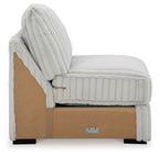 Light gray armless upholstered chair with high back, visible base, and channel quilting.