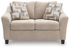 Taupe upholstered loveseat with two seat cushions and two geometric throw pillows