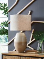 Cream beige table lamp with linen drum shade and speckled base on shelf