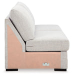 Light gray armless loveseat with high back cushion and exposed base panel