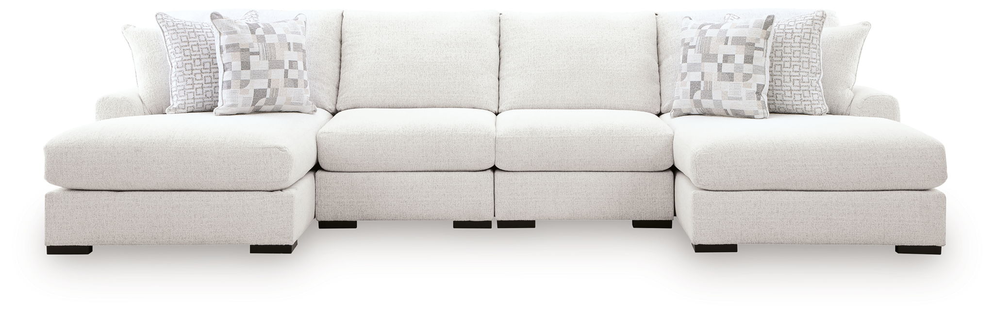 Light beige sectional sofa with chaise seating and multiple patterned throw pillows