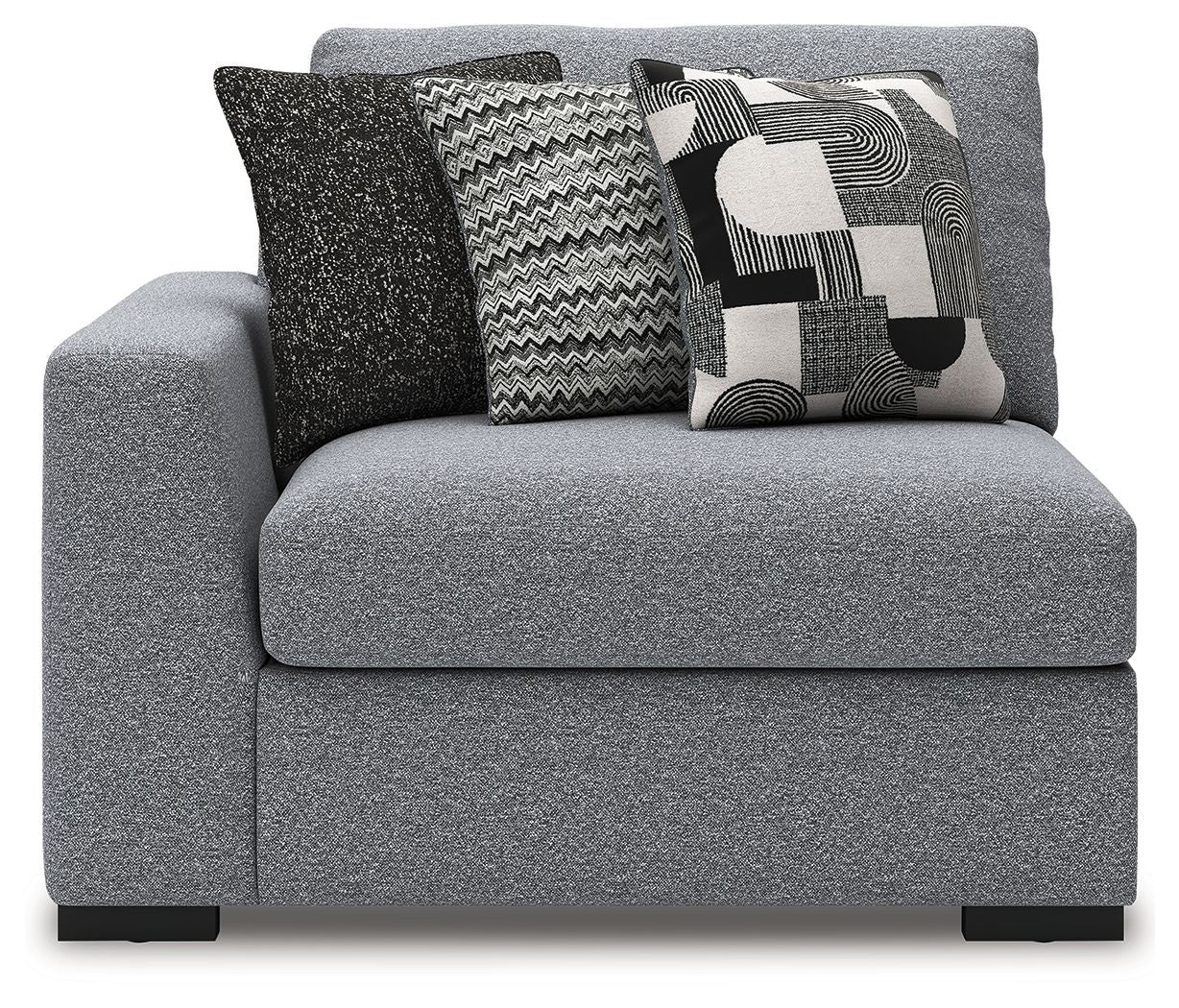 Gray upholstered corner chair with thick armrests, black legs, and three patterned cushions