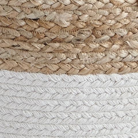 Close-up of woven pouf fabric with tan top and light gray braided stripes.