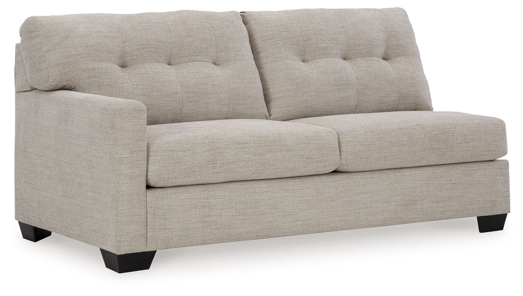 Pebble gray sofa sleeper section with tufted back, padded armrests, and square legs