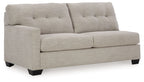Pebble gray sofa sleeper section with tufted back, padded armrests, and square legs