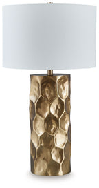 Gold metal table lamp with faceted texture base and white fabric drum shade