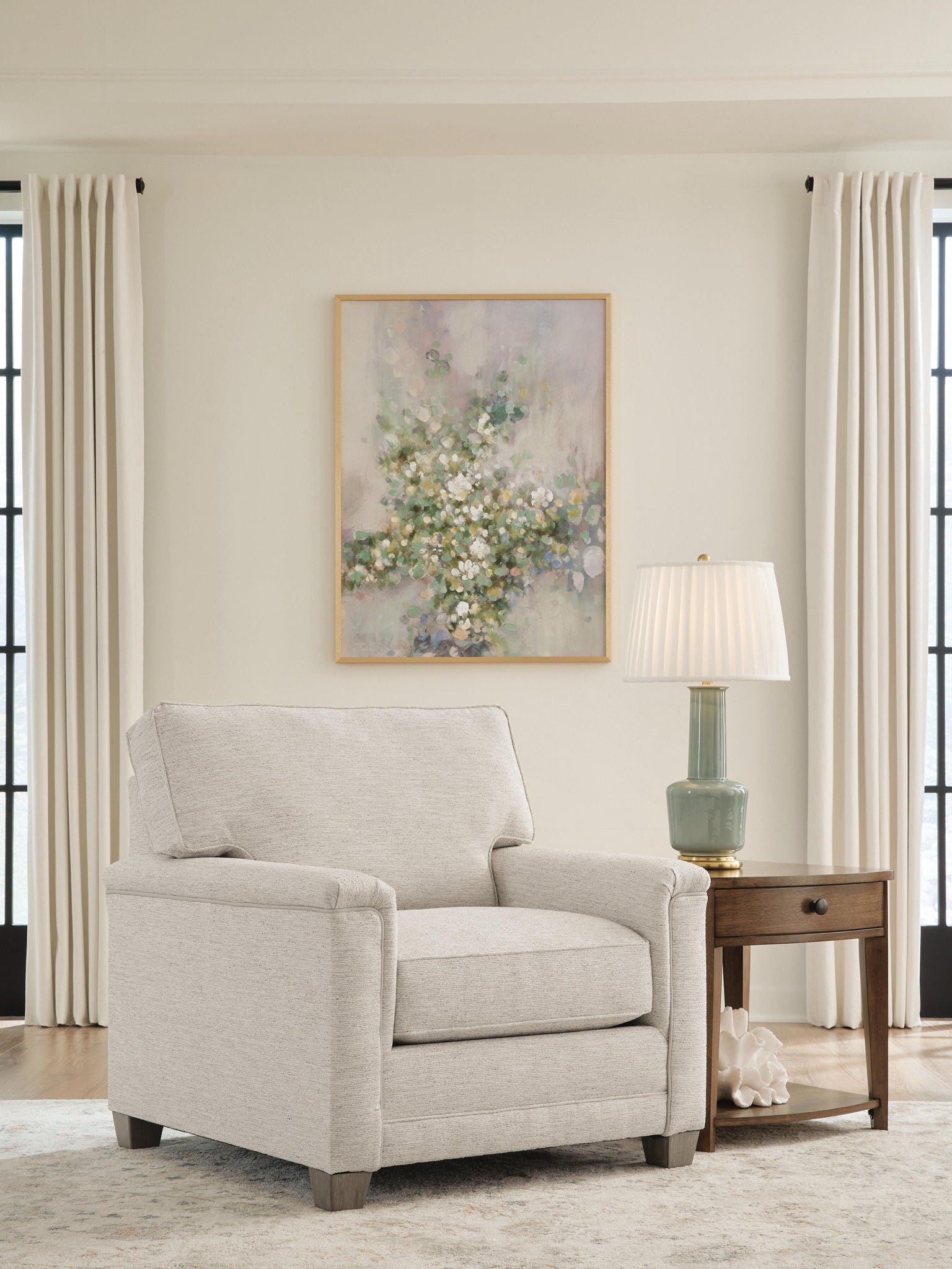Light beige upholstered accent chair with rolled arms and tufted back panel