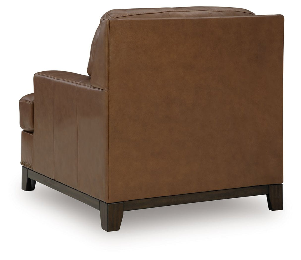 Amber leather armchair side view with thick arms, padded back, and wooden feet