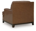 Amber leather armchair side view with thick arms, padded back, and wooden feet