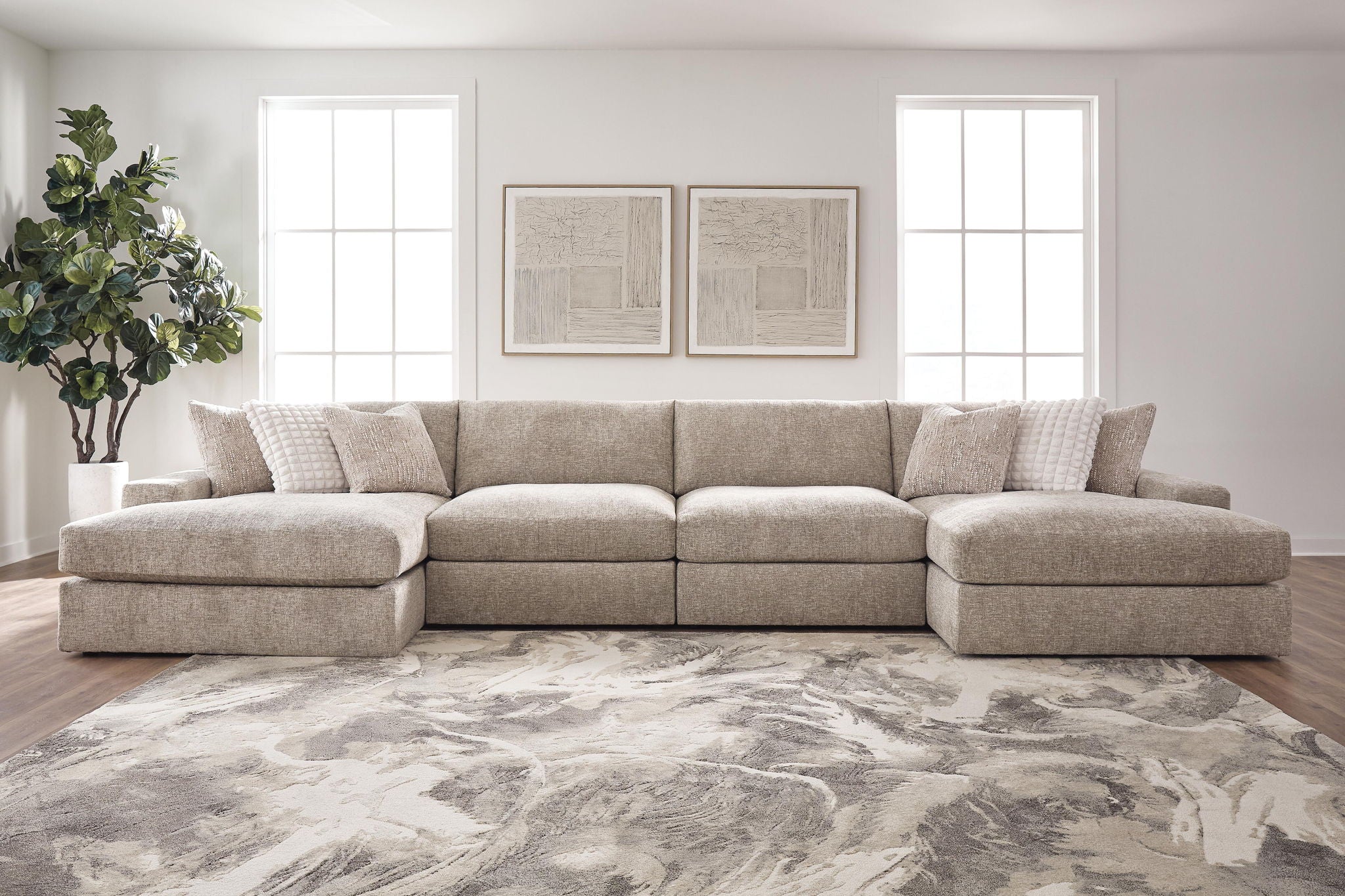 Tan burlap-upholstered sectional sofa with chaise extension and pillow accents