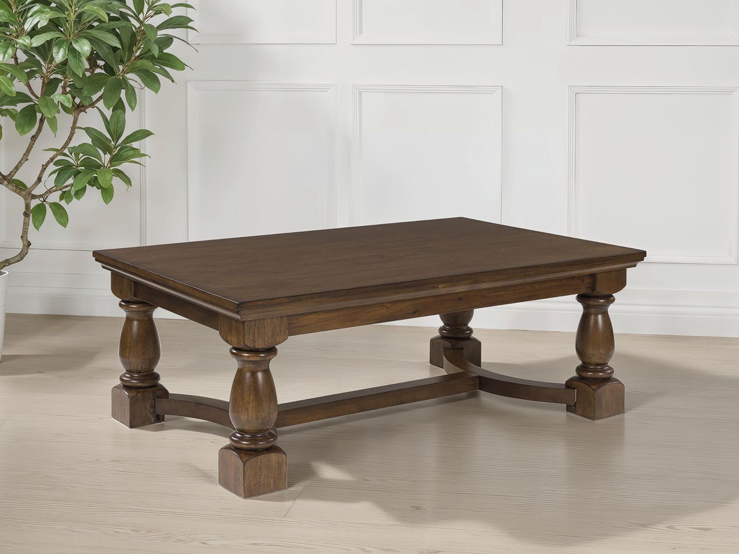 Rectangular brown cocktail table with turned legs and curved apron, flat top
