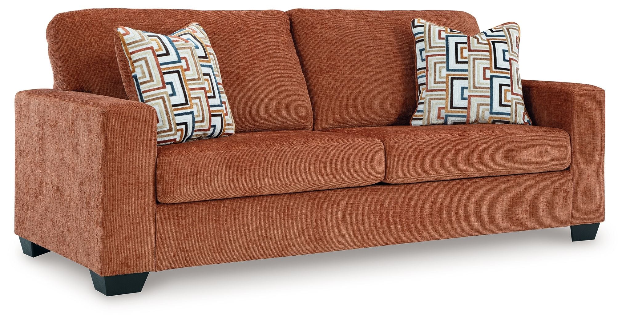 Spice rust sofa sleeper with two patterned throw pillows, front view.