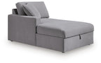 Gray corner chaise with storage, long seat section and tufted seat cushion