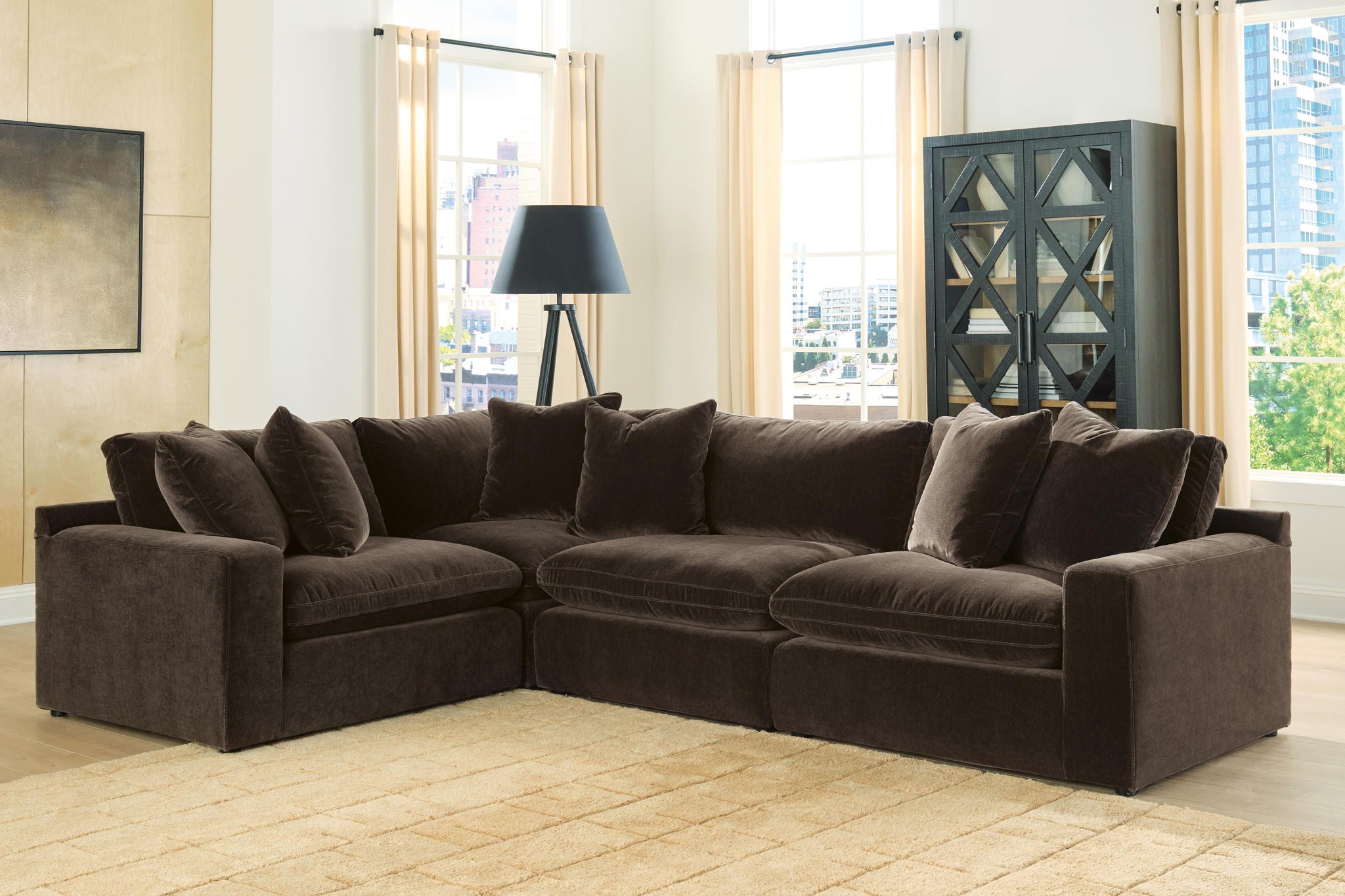 Dark brown sectional sofa with corner chaise, square arms, and layered back cushions and pillows.