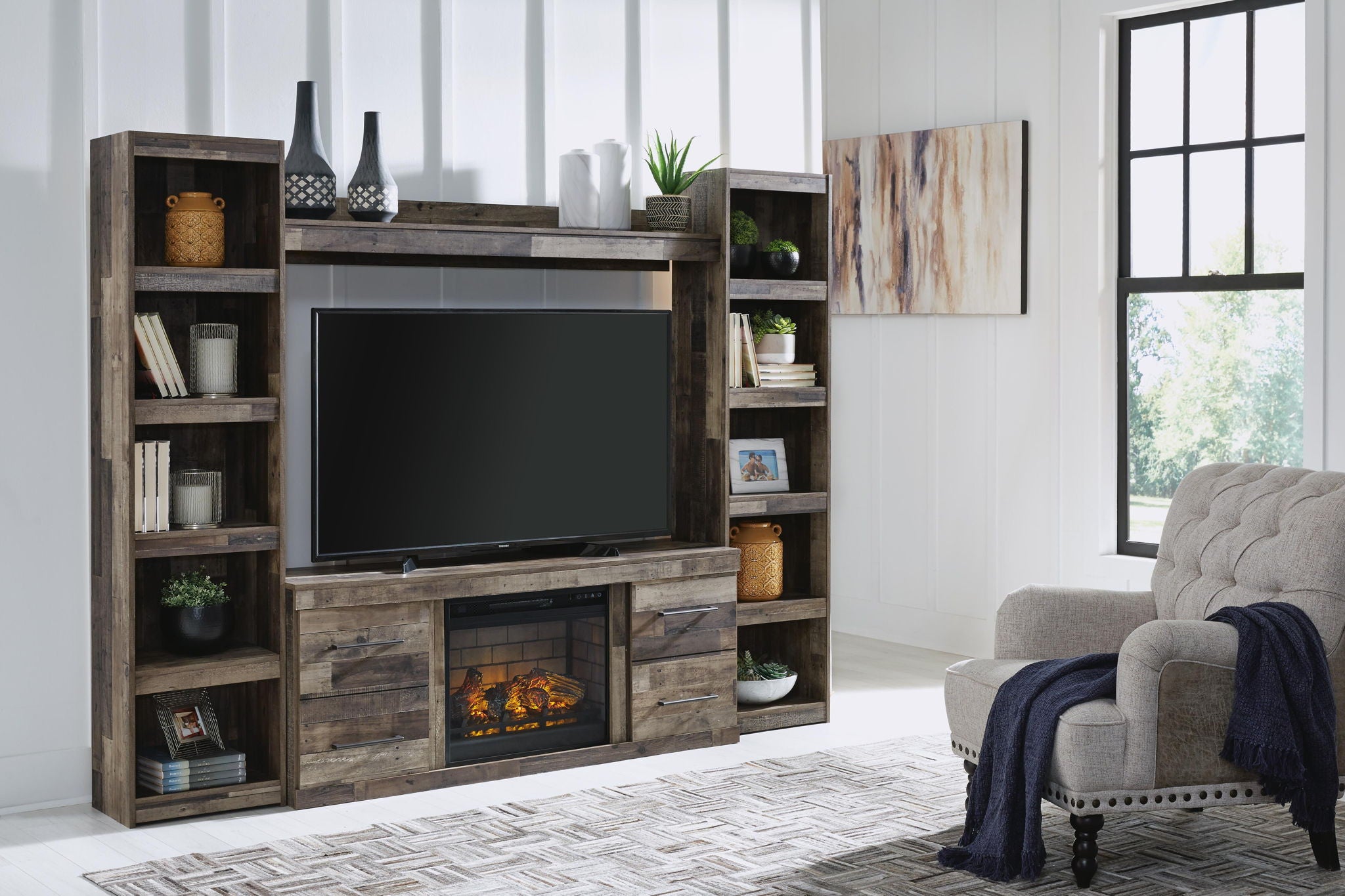 Derekson dark gray entertainment center with TV mount, electric fireplace, and storage shelves