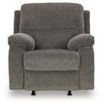 Dark gray rocker recliner chair with wide padded arms and recline-ready seat